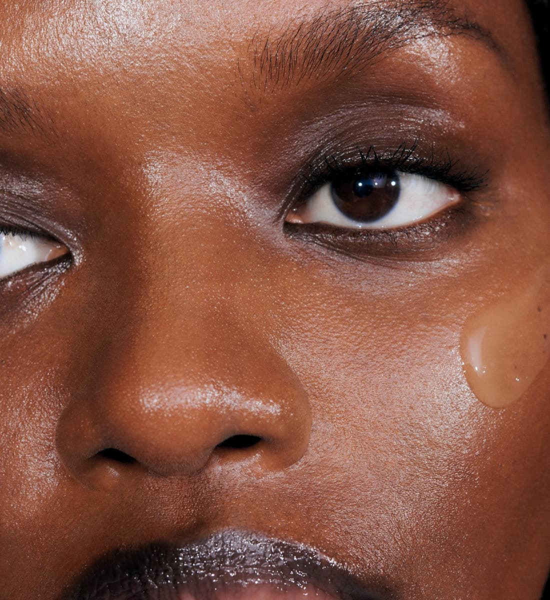 a close up of a model's skin with a swatch of pineapple refresh on her face