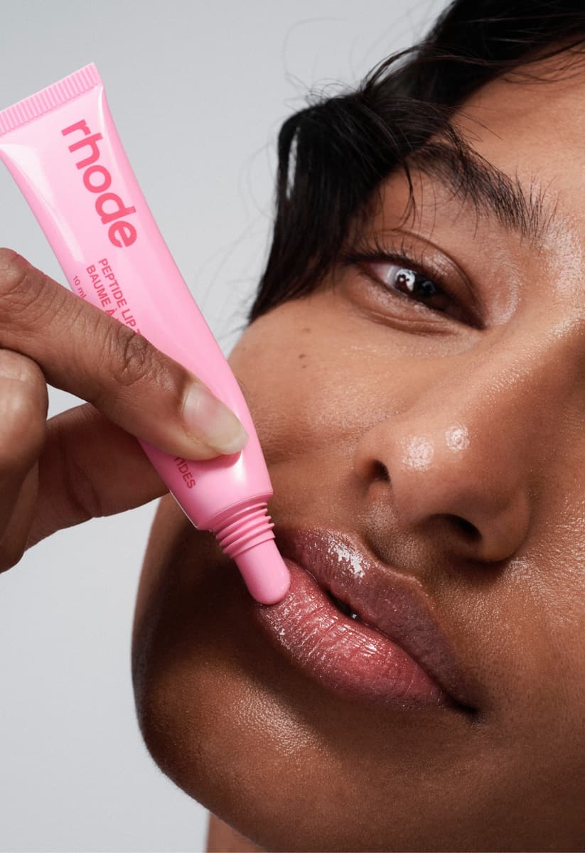 model wearing peptide lip tint in jelly bean