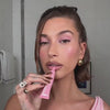 Video of Hailey Bieber applying ribbon lip tint on lips