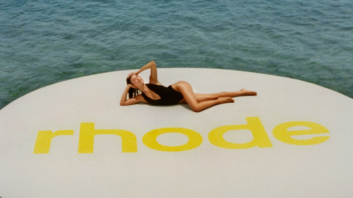 HB lying down on a giant float with rhode logo